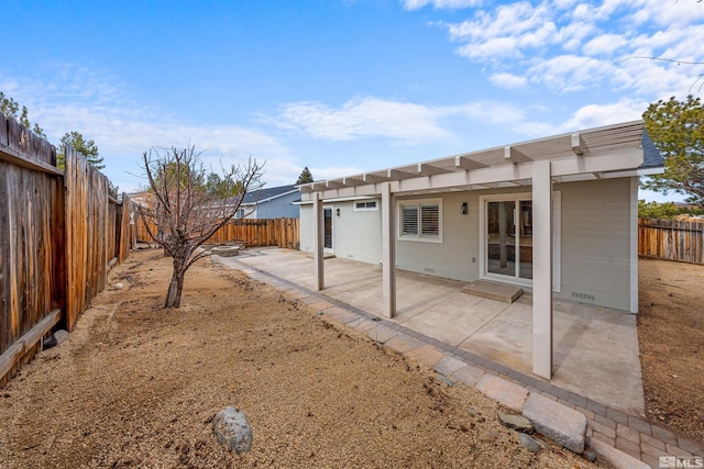 back of house with crawl space, a fenced backyard, and a patio