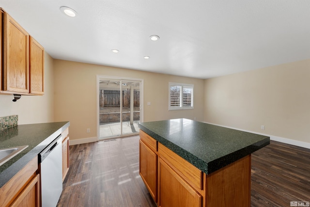 kitchen featuring dark countertops, recessed lighting, baseboards, dishwasher, and dark wood-style flooring