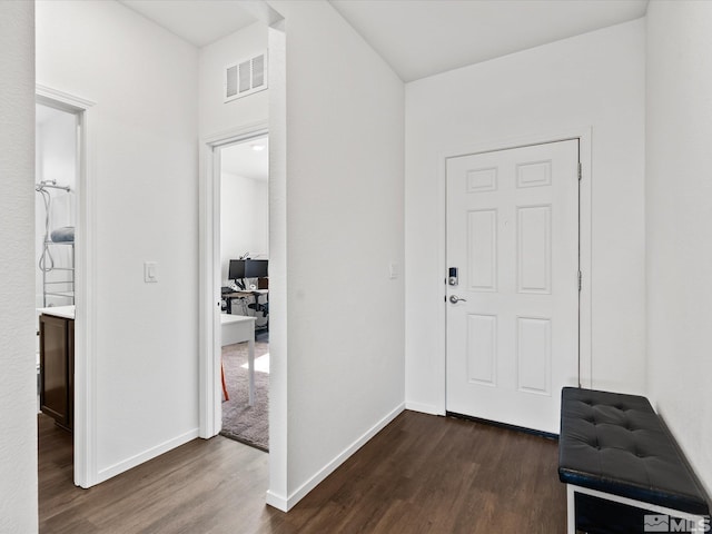 entrance foyer with dark wood-style floors, visible vents, and baseboards