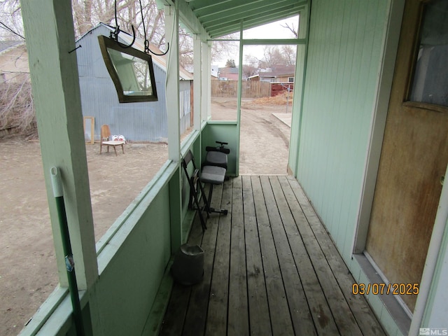 unfurnished sunroom with lofted ceiling