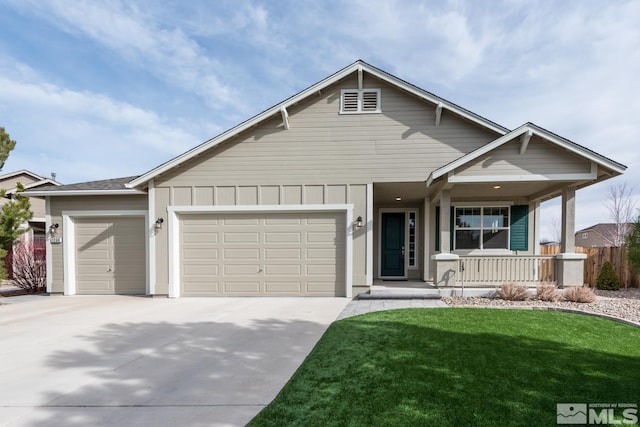 view of front of house featuring a front yard, driveway, covered porch, a garage, and board and batten siding