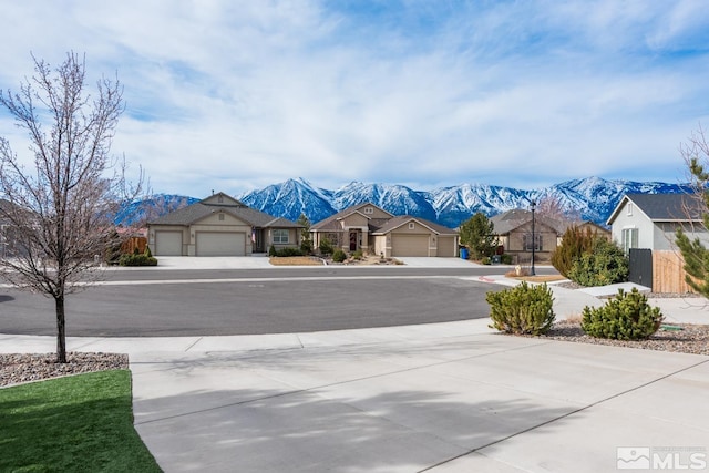 view of street with a mountain view and driveway