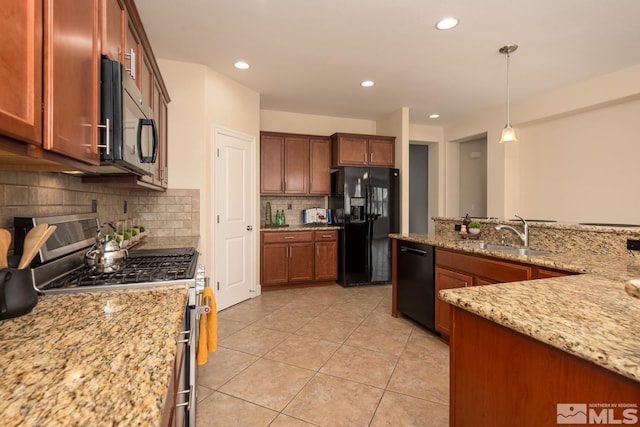 kitchen with decorative light fixtures, light tile patterned floors, light stone counters, black appliances, and a sink