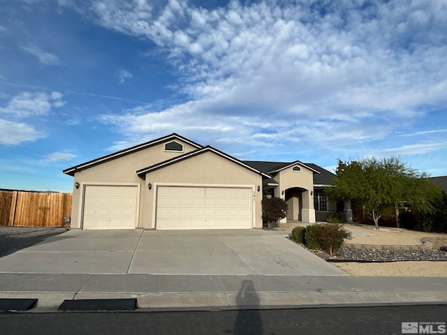 single story home with stucco siding, driveway, a garage, and fence