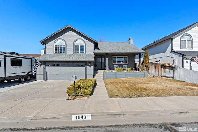 view of front of house featuring a front yard, fence, a shingled roof, concrete driveway, and a garage