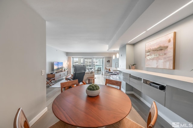 dining room featuring baseboards and wood finished floors