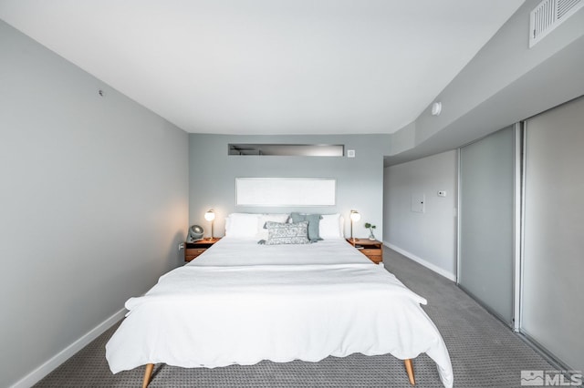 carpeted bedroom with baseboards and visible vents