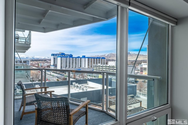 balcony featuring a mountain view and a view of city