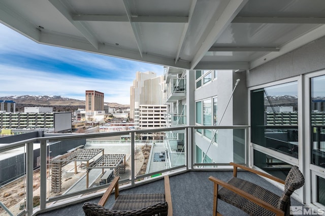 balcony with a mountain view and a city view