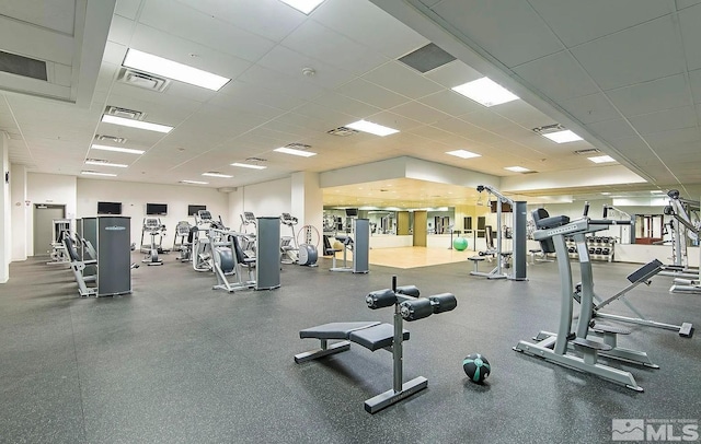 workout area with a drop ceiling and visible vents