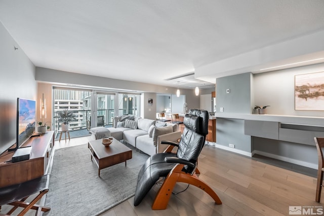 living area featuring wood finished floors and baseboards