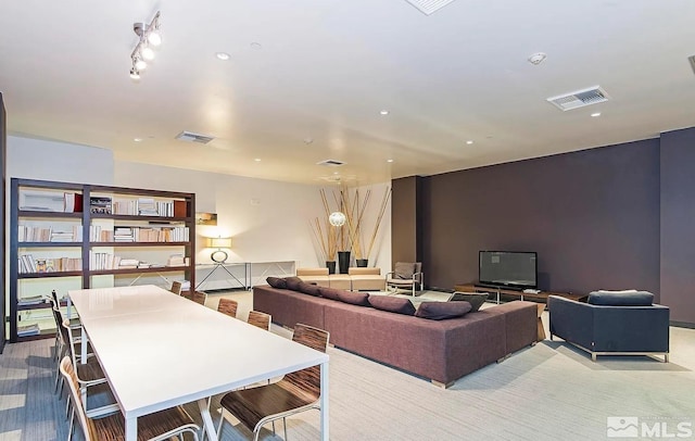 living room with rail lighting, recessed lighting, and visible vents