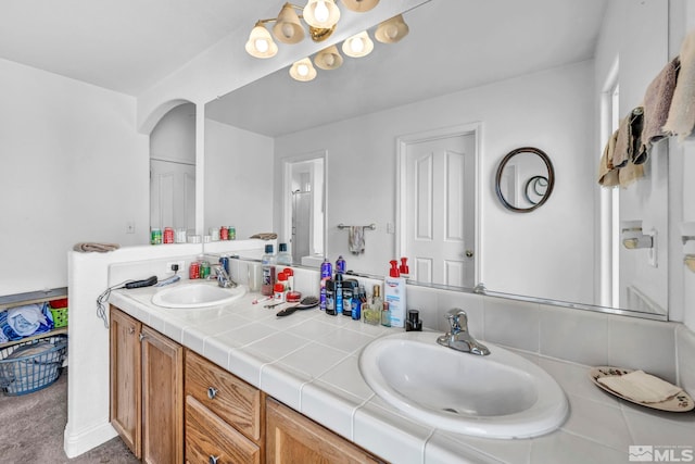 full bathroom featuring a sink and double vanity