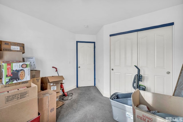 interior space featuring baseboards and carpet