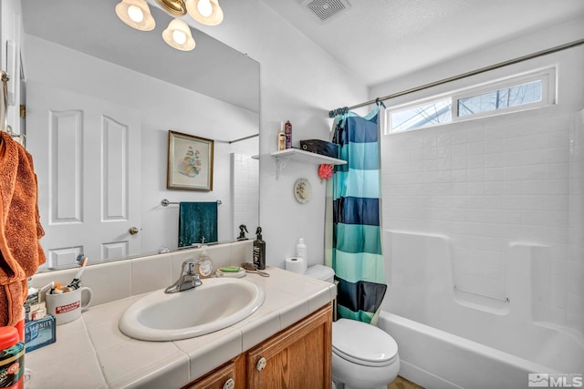 full bath with visible vents, shower / bath combination with curtain, toilet, and vanity