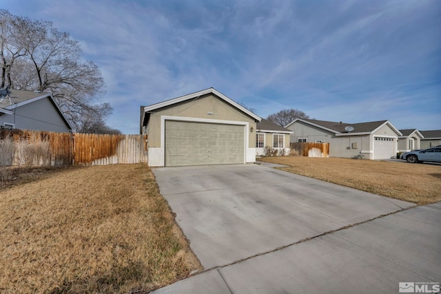 ranch-style home featuring a front lawn, an attached garage, fence, and driveway