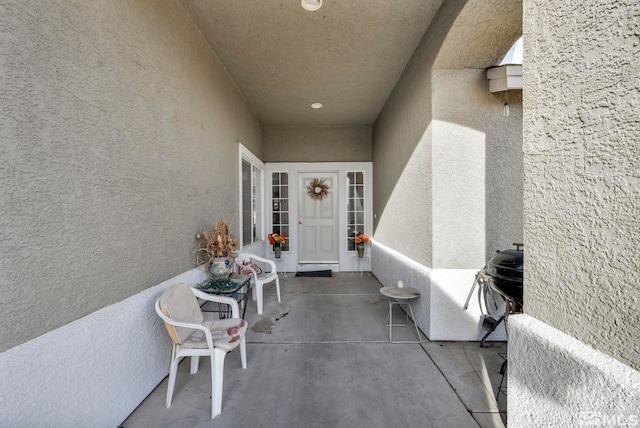 doorway to property with stucco siding and a patio