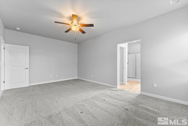 carpeted empty room with baseboards and ceiling fan