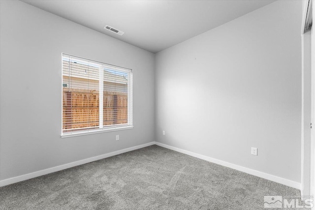 carpeted empty room with baseboards and visible vents