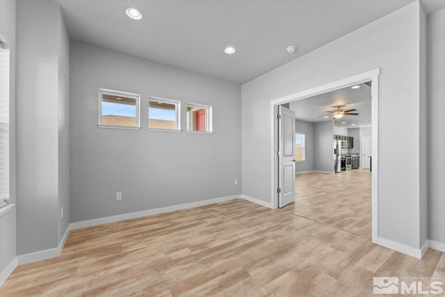 empty room featuring recessed lighting, light wood-style flooring, baseboards, and ceiling fan