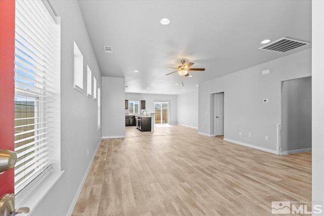 unfurnished living room with recessed lighting, a ceiling fan, visible vents, and light wood-type flooring