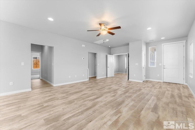 unfurnished living room with light wood finished floors, baseboards, ceiling fan, recessed lighting, and plenty of natural light