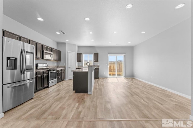 kitchen with light wood-type flooring, visible vents, baseboards, and appliances with stainless steel finishes