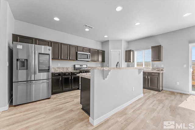 kitchen featuring recessed lighting, visible vents, appliances with stainless steel finishes, and light wood-type flooring