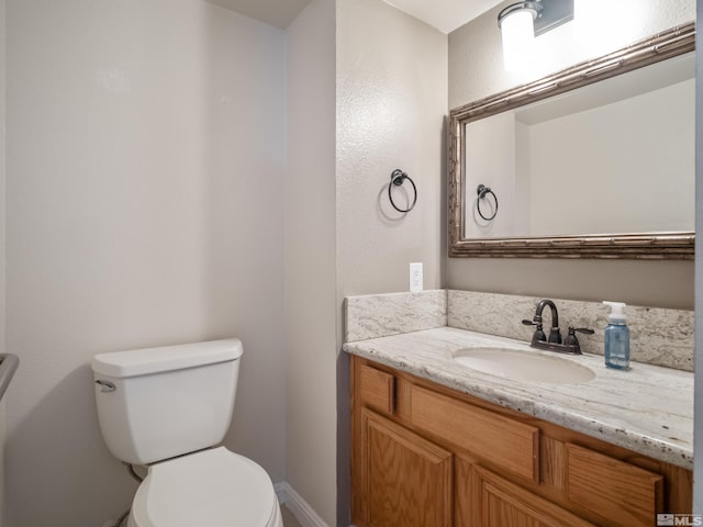 bathroom with toilet and vanity