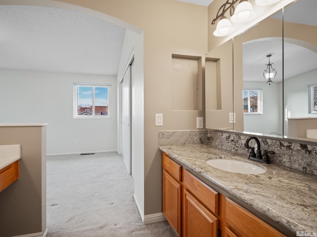 bathroom with visible vents, baseboards, and vanity