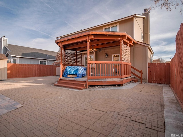 view of patio with a deck and a fenced backyard