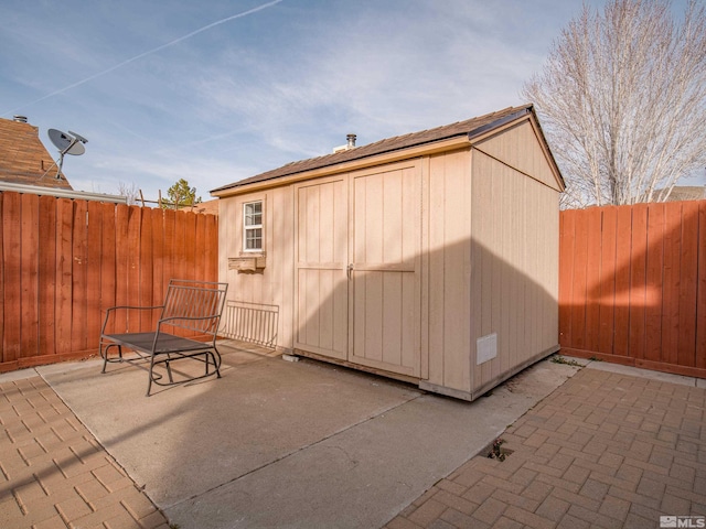 view of shed featuring a fenced backyard