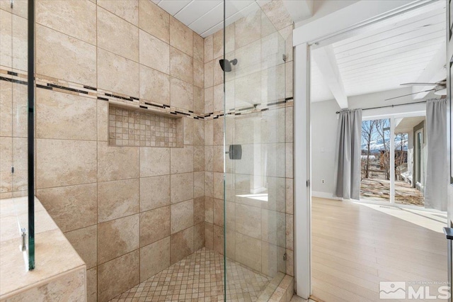 full bathroom featuring beamed ceiling, a stall shower, and ceiling fan