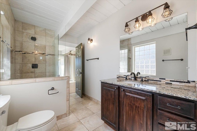 bathroom featuring tile patterned flooring, a walk in shower, toilet, beam ceiling, and vanity