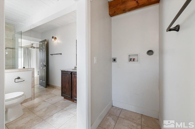 full bath featuring beamed ceiling, toilet, tile patterned flooring, baseboards, and vanity