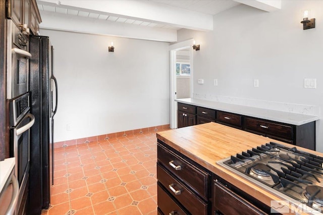 kitchen with beam ceiling, dark brown cabinetry, and stainless steel appliances