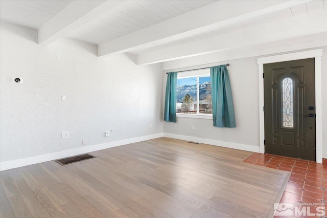 entrance foyer featuring wood finished floors, beamed ceiling, baseboards, and visible vents