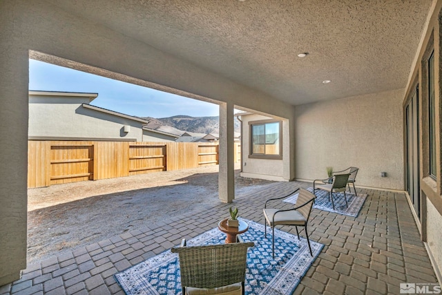 view of patio / terrace with a fenced backyard and a mountain view