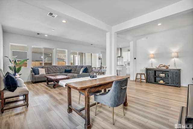 living room with recessed lighting, light wood-style floors, visible vents, and baseboards