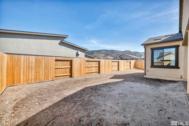 view of yard with a mountain view and a fenced backyard