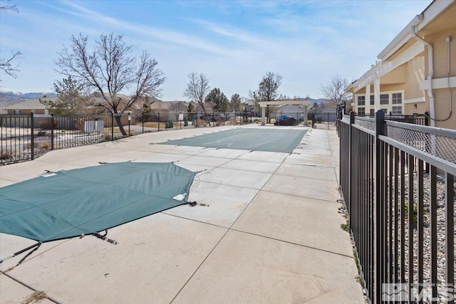 pool featuring a patio area, a residential view, and fence