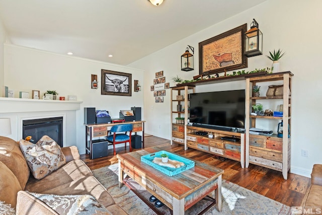 living area with a glass covered fireplace, recessed lighting, baseboards, and wood finished floors