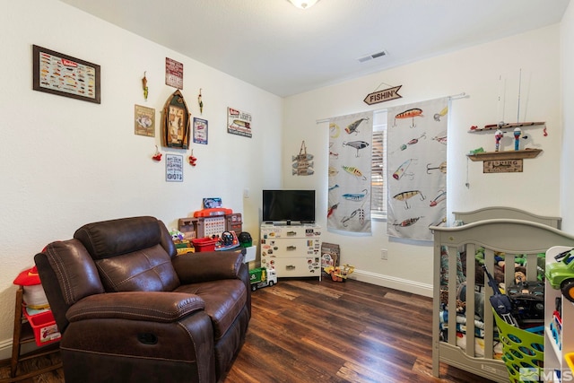 sitting room featuring wood finished floors, visible vents, and baseboards