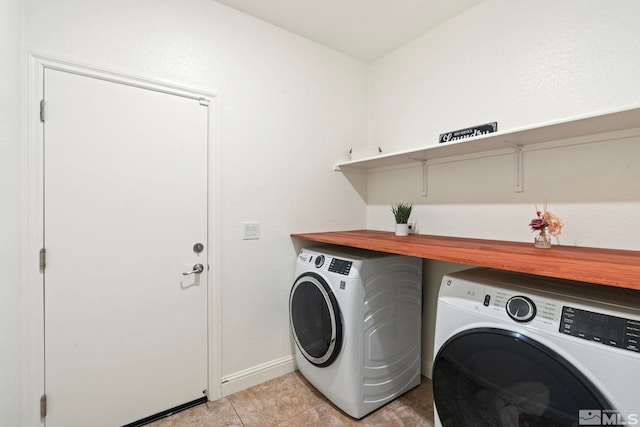 laundry area with laundry area, light tile patterned flooring, baseboards, and independent washer and dryer