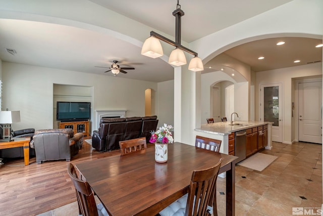 dining space with arched walkways, recessed lighting, and ceiling fan