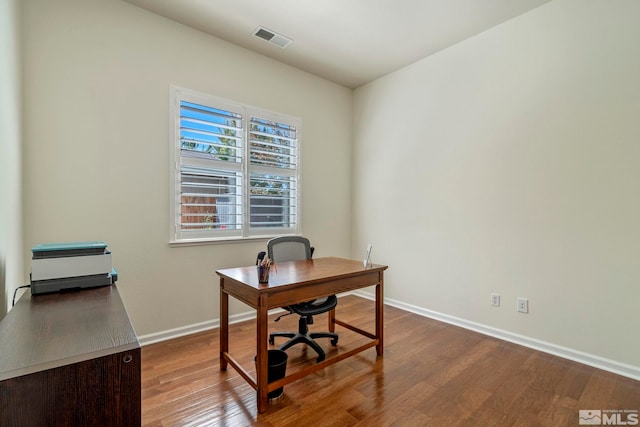 office area featuring wood finished floors, visible vents, and baseboards