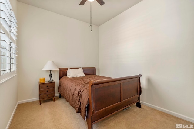 bedroom featuring baseboards, light carpet, and a ceiling fan