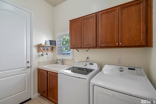 washroom with separate washer and dryer, light tile patterned floors, cabinet space, and a sink