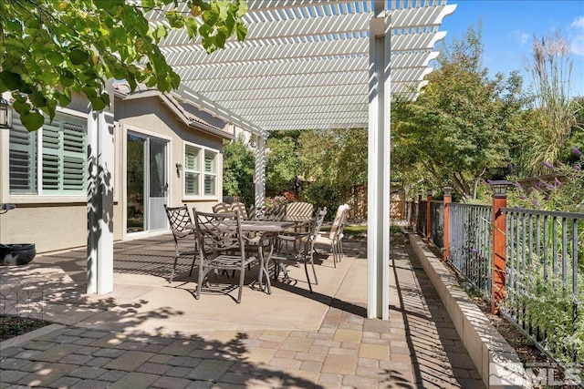 view of patio with outdoor dining space, a pergola, and fence