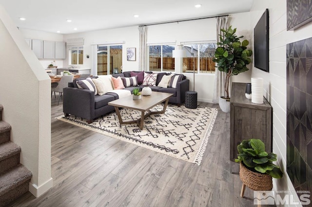 living area featuring stairway, recessed lighting, and wood finished floors